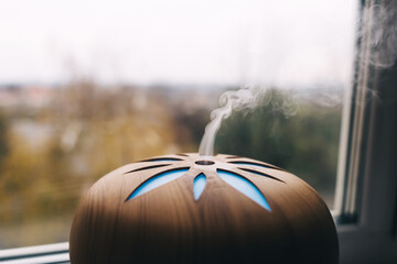 Air humidifier. Aroma diffuser close-up. A stream of steam close-up and other details blurry. The...