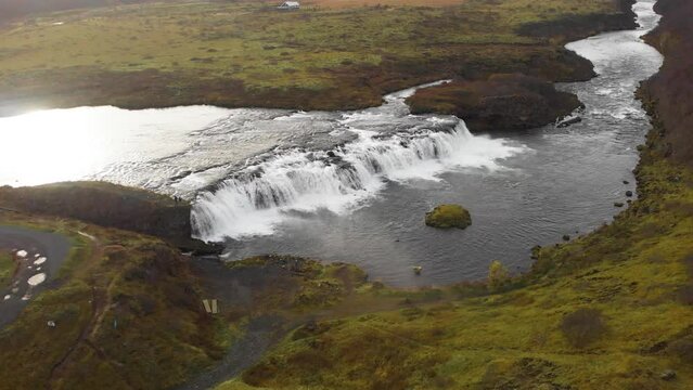 Sunlight reflecting in flowing Faxi waterfall river stream, Iceland.