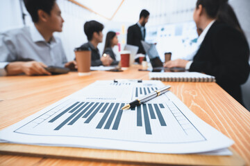 Focus financial dashboard paper showing graphs and chart with blurred background of diverse...
