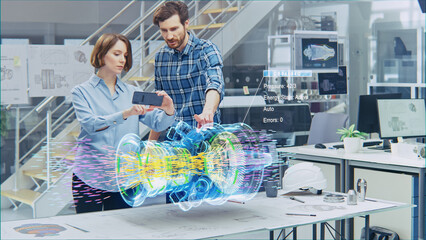 Engineering Facility: Female Designer with Chief Engineer Use Smartphone with Augmented Reality App to Manipulate 3D Engine. Specialists Working on Eco-Friendly Green Energy Turbine.