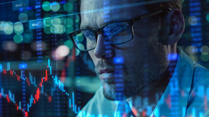 Stock Market Trader Working with Investment Charts, Graphs, Ticker Numbers Projected on Face and Reflecting in Glasses. Financial Analyst, Digital Entrepreneur doing Social Trading with an App.
