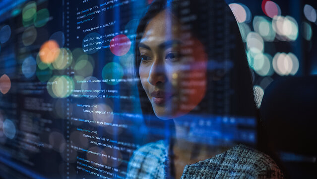 Portrait of Asian Female Startup Digital Entrepreneur Working on Computer, Line of Code Projected on Her Face and Reflecting. Software Developer Working on Innovative e-Commerce AI App, Big Data.