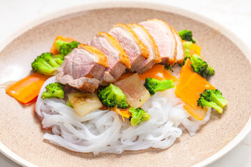 baked duck breast with vegetables and rice noodles