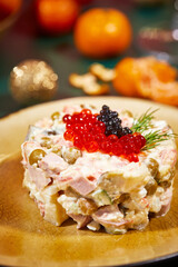 Close-up of plate with portioned Olivier salad on the New Year's table. Party in Russian style