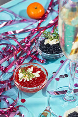 Two bowls with red and black caviar on the New Year's table. Party in Russian style