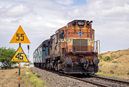 Diesel locomotive hauling a passenger train on curve in Shindawane, Maharashra.