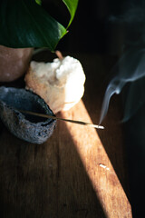 incense burning and smoking with a cinematic light coming through the scene