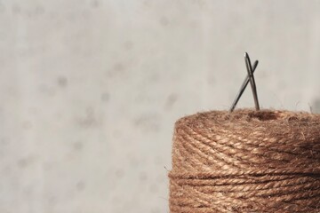 Jute needle roll with white background and space for text.
