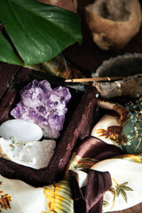 amethyst geode in a wooden box with quartz and selenite with incense stick