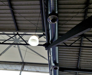 air conditioning vent pipe with tilting pipe diffuser. the ceiling of an industrial building with...