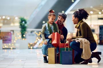 Happy multiracial family checking their shopping bags while buying at mall at Christmas.