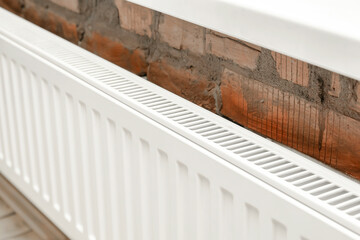 White heat radiator by window.Centralized heating in apartment,home in winter cold weather season, warming up