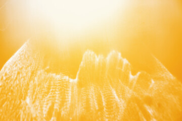 White shiny glare from sunlight on yellow background, abstract nature photo with sunshine flare,...