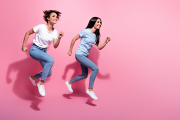 Full body photo of two running funky women have fun fast speed last chance buy clothes discount...