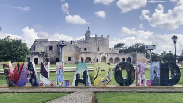 Valladolid city art installation sign in front of historic colonial brick building