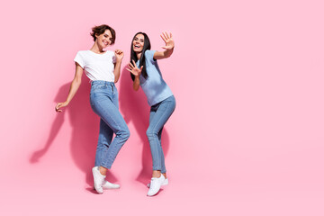 Full body photo of two models dancing young girls high five discount promoting shopping center have...