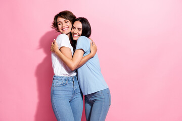Portrait of two funky girls hugs together lovers perfect match lesbians carefree support sweetheart isolated on pink color background