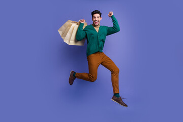 Fototapeta na wymiar Photo of cheerful excited crazy man wear stylish outfit celebrate rejoice seasonal sale isolated on violet color background