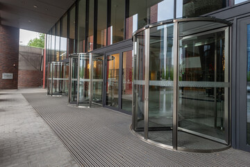 Facade of modern Business Center with glass doors - obrazy, fototapety, plakaty