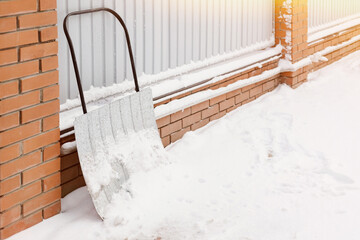 City cleaning service. Close-up of shovel. Snow, winter, snowstorm yard. Sunlight