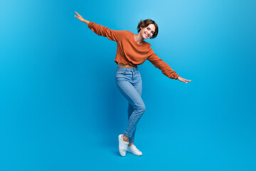 Fototapeta na wymiar Full body size photo of pretty lady slim figure dancing arms like wings wear casual outfit isolated blue color background