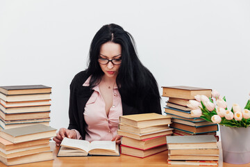 Female school librarian with books for university study