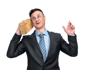 A happy man in a jacket and tie is talking on the phone with a yellow brick pressed to his ear, isolated on a transparent background png