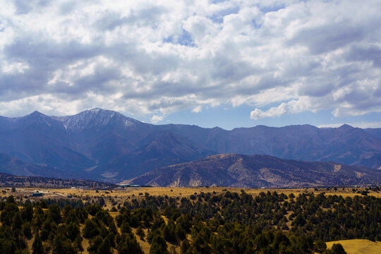 Mountains covered with grass and trees and cloudy dramatic sky on a daytime in Zaamin reserve.