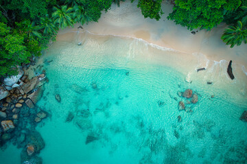 Bird eye drone shot of beautiful white sandy beach, turquoise water and granite stones, Mahe Seychelles 4