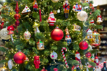 Large Christmas tree decorated with colored balls and puppets