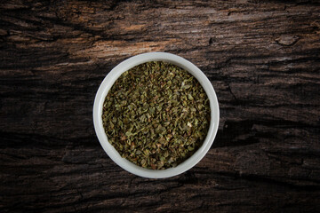 Dried Oregano spice in a white bowl