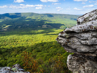 Fototapeta na wymiar The beautiful wilderness with wooded mountains with rocks in the foreground as seen from Big Schloss via Wolf Gap Trail on the border between West Virginia and Virginia.