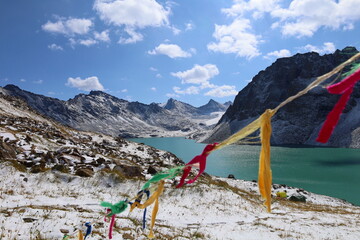 Ala-köl mountain lake with fresh snow during summer in Tian Shan mountains, Karakol, Kyrgyzstan - obrazy, fototapety, plakaty