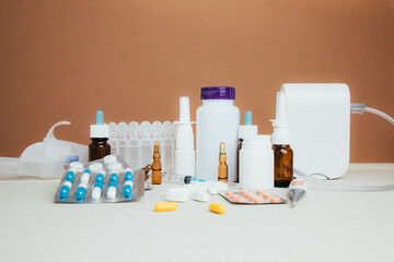 A set of medicines for treatment in bottles and tablets in transparent plates on a light background. Front view