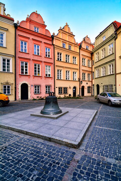 Warsaw, Poland, Europe - facades of townhouses and bell formely installed in St John's Archcathedral, Kanonia square, Old Town - UNESCO World Heritage Site