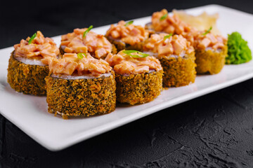 Hot fried sushi roll on white plate