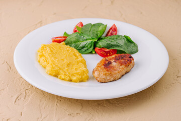 polenta with cutlet and cherry tomatoes with basil
