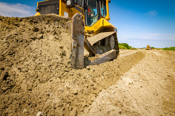 Crawler tracks, bulldozer machine is leveling construction site