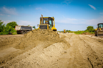 Bulldozer machine is leveling construction site.