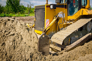 Crawler tracks, bulldozer machine is leveling construction site