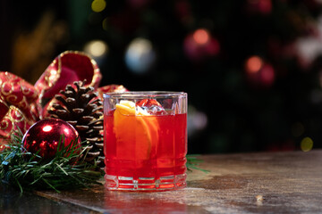 glass of campari red negroni drink in Christmas atmosphere on the pub counter