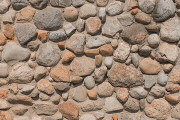Stones cobblestones in cement wall solid texture background
