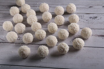 photo a delightful assortment of homemade coconut candy balls takes center stage against a white background. These round treats, a tasty. Each bite offers a sweet and satisfying burst of flavor 