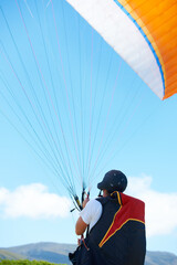 Nature, sport or man with parachute in preparation, launch or paragliding training for adventure in extreme exercise. Person, balance or strings for outdoor fun or fitness with helmet or safety gear