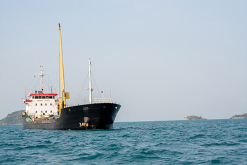 cargo ship in the ocean for export import goods from cargo yard port to customs ocean concept freight shipping by ship