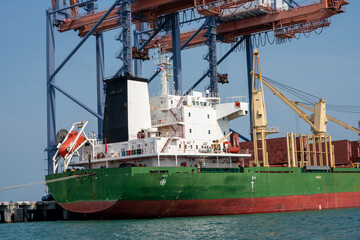 crane loading cargo container from truck to container ship in the international terminal logistic sea port concept freight shipping by ship, webinar banner forwarder mast.