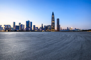 Asphalt road square and urban skyline with modern buildings at dusk in Shenzhen, Guangdong Province, China. Road square and skyline background.