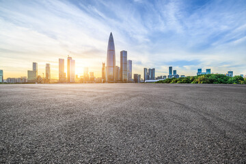 Asphalt road and urban skyline with modern buildings at sunset in Shenzhen, Guangdong Province, China. - obrazy, fototapety, plakaty