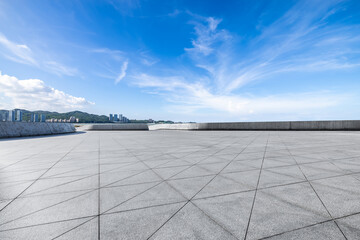Empty square floor and skyline under blue sky