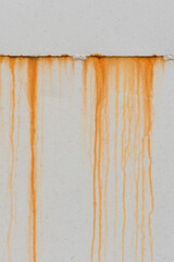 Rusty orange streaks rust on metal fence surface view old texture background